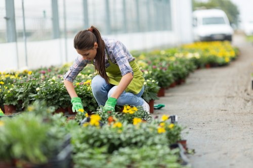 Gardeners working safely with tools and protective equipment